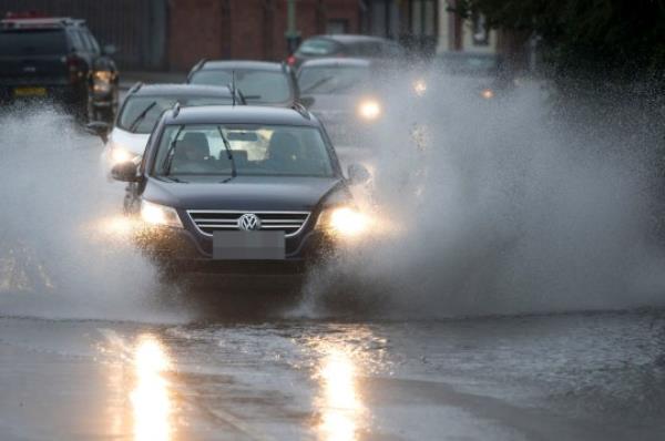 PONTYPRIDD, WALES - AUGUST 16: A car drives through a flooded road on August 16, 2019 in Pontypridd, Wales. The Met Office have issued a yellow weather warning for rain for Wales and the southwest of England and have warned that some homes and businesses could be at risk of flooding. (Photo by Matthew Horwood/Getty Images)