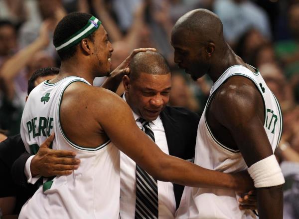 Boston Celtics' Paul Pierce (L) and Kevin Garnett (R) hug head coach Doc Rivers (C) after winning Game 6 of the 2008 NBA Finals