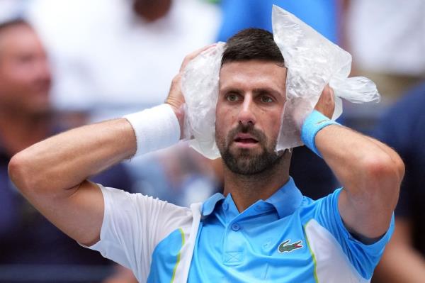 Novak Djokovic cools off with two bags of ice at the US Open.