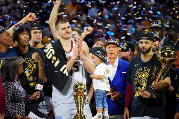 Nikola Jokic celebrates with teammates after the team won the NBA Champio<em></em>nship with a victory over the Miami Heat in Game 5 of basketball's NBA Finals.