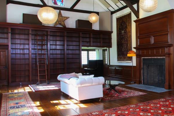 The great room has a 26-foot-high ceiling, with bookshelves accessed by a rolling library ladder.