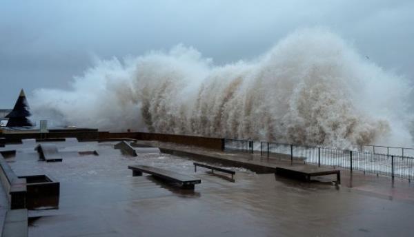 Waves crash o<em></em>nto a harbour jetty during Storm Ciaran.