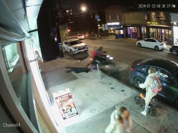 Surveillance footage of a migrant on a moped dragging a woman while stealing her cellphone.