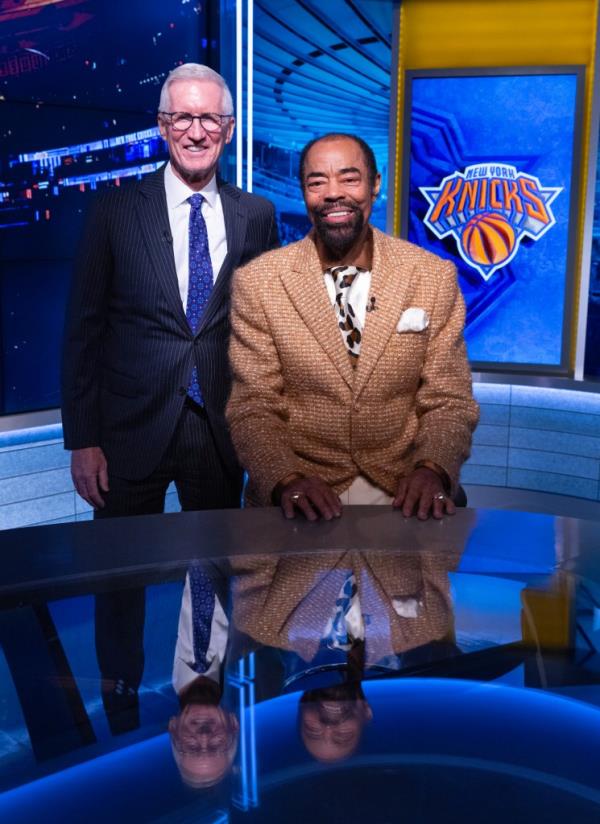 Mike Breen and Walt Clyde Frazier standing next to each other in the MSG Networks Studios, celebrating their 25th anniversary of broadcasting together.