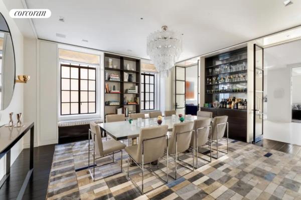 The interior of a dining room with a glass chandelier and a table, located at 9 East 79th Street as seen on cityrealty.com.