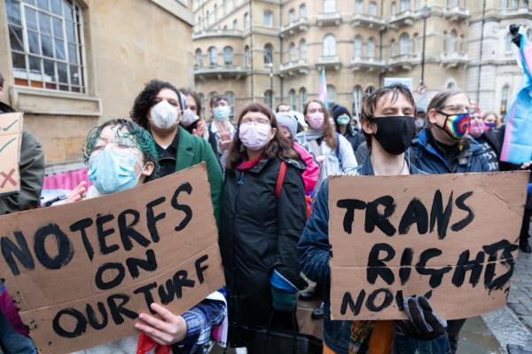 2022/01/08: Protestors hold placards saying 'no terfs on our turf' and 'trans rights now' during the demonstration.