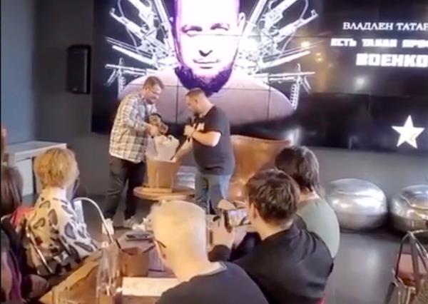 Video shows Tatarsky examining the gift brought to him by Trepova