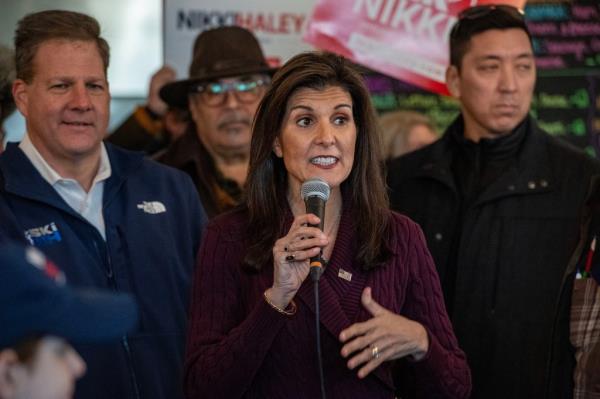 Former UN Ambassador and 2024 presidential hopeful, Nikki Haley, with New Hampshire Governor Chris Sununu (L), speaks to supporters at Robie's Country Store in Hooksett, New Hampshire, on January 18, 2024. 