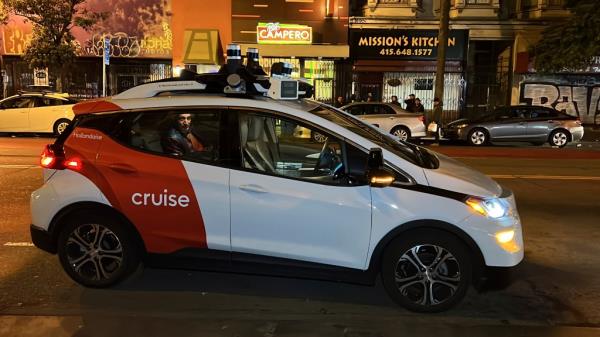 Associated Press reporter Michael Liedtke sits in the back of a Cruise driverless taxi that picked him up in San Francisco's Mission District