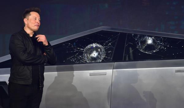 Tesla co-founder and CEO Elon Musk reacts in front of the newly unveiled all-electric battery-powered Tesla Cybertruck with broken glass on windows following a demo<em></em>nstration on Nov. 21, 2019.