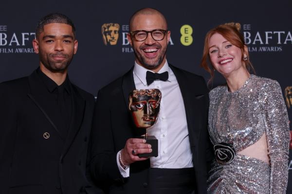 Kingsley Ben-Adir, best adapted screenplay winner Cord Jefferson and  Bryce Dallas Howard pose for photos after the BAFTas.