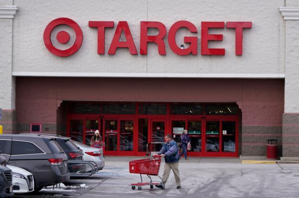 A shopper pushing a cart outside a Target store.