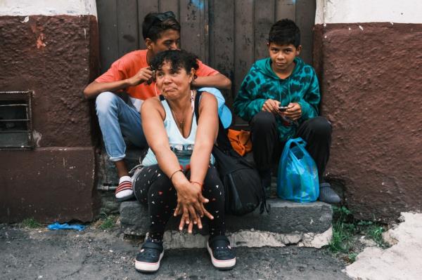 Beibis Roman and her two sons sitting on a stoop in Ecuador