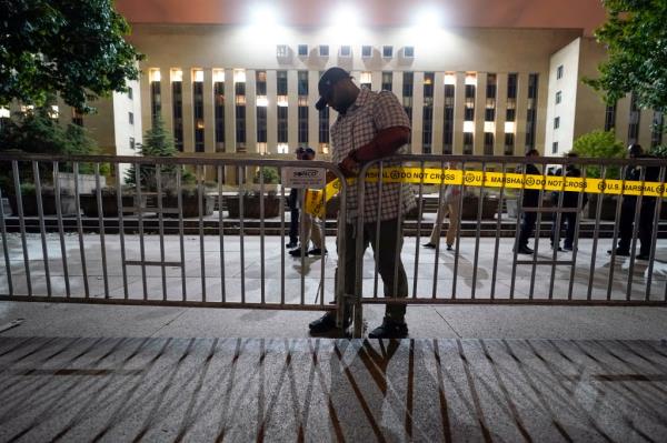 Workers put up barricades and secure the area outside the E. Barrett Prettyman U.S. Federal Courthouse, Wednesday, Aug. 2, 2023, in Washington.