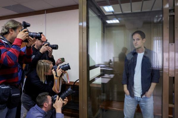 Wall Street Journal reporter Evan Gershkovich stands inside an enclosure for defendants before a court hearing to co<em></em>nsider an appeal against his pre-trial detention on espio<em></em>nage charges in Moscow, Russia.