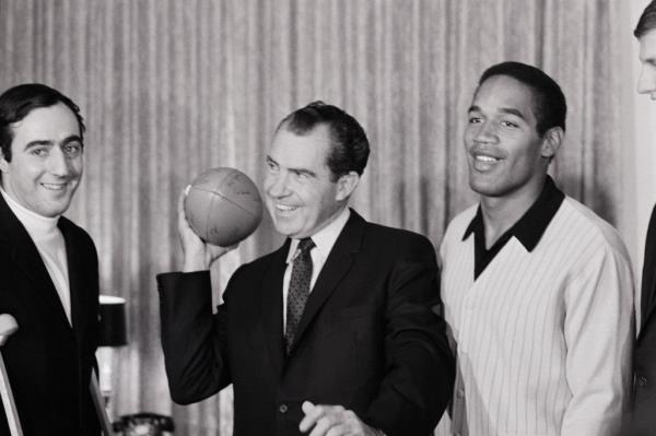 O.J. stands next to President-elect Richard Nixon in 1968.