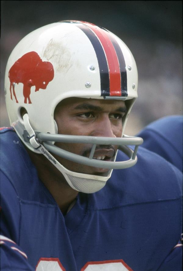 O.J. on the sidelines of a game wearing a Buffalo Bills helmet.