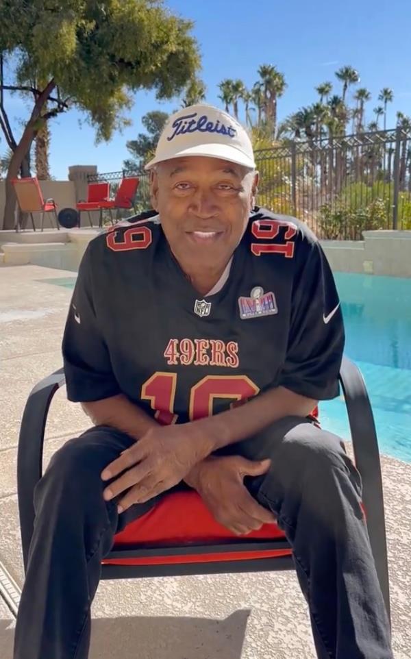 OK Simpson in a 49ers shirt in front of a pool.