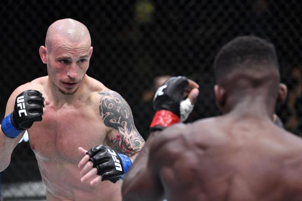 LAS VEGAS, NEVADA – APRIL 10: (L-R) Sasha Palatnikov of Hong Kong battles Impa Kasanganay in a welterweight fight during the UFC Fight Night event at UFC APEX on April 10, 2021 in Las Vegas, Nevada. (Photo by Chris Unger/Zuffa LLC)