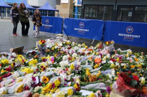 People lay flowers and messages in tribute to Nottingham Panthers' ice hockey player Adam Johnson outside the Motorpoint Arena in Nottingham, the home of the Panthers. Mr Johnson died after an accident during a Challenge Cup match with Sheffield Steelers on Saturday night. Picture date: Mo<em></em>nday October 30, 2023. PA Photo. See PA story ICEHOCKEY Nottingham. Photo credit should read: Jacob King/PA Wire