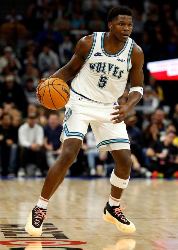 Minnesota Timberwolves guard Anthony Edwards dribbles the ball against the Indiana Pacers in the fourth quarter at Target Center on December 16, 2023 in Minneapolis, Minnesota. 