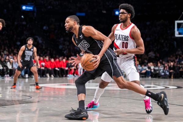 Nets forward Mikal Bridges (1) drives past Portland Trail Blazers guard Scoot Henderson