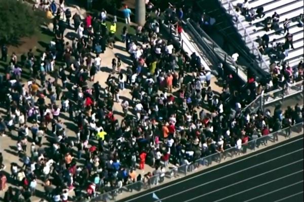 Students and staff gather next to the football field after law enforcement officers respo<em></em>nded to a fatal shooting at Apalachee High School in a still image from aerial video in Winder, Georgia, U.S. September 4, 2024