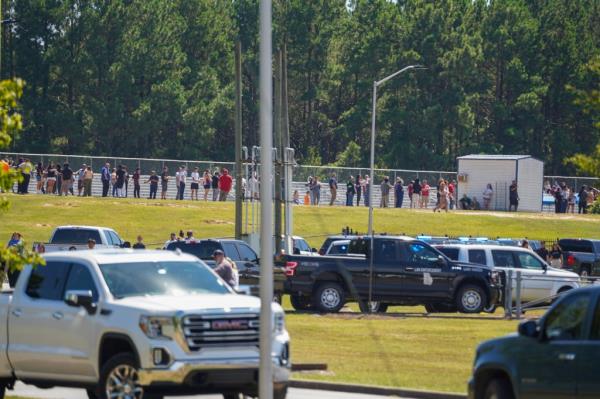 Students and family members are line up nearby after a shooting at Apalachee High School on September 4, 2024 in Winder, Georgia. 