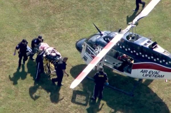 The scene outside Apalachee High School in Winder, Georgia, as a wounded individual is escorted by medical perso<em></em>nnel o<em></em>nto a helicopter.