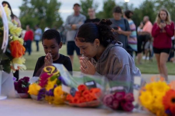 People pray during a vigil for the Apalachee High School shooting at Jug Tavern Park in Winder, Georgia, on September 4, 2024