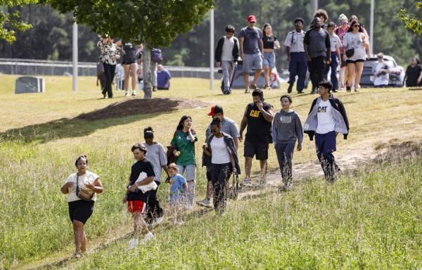 Parents and students leave the site of a shooting at Apalachee High School in Winder, Georgia, USA, 04 September 2024