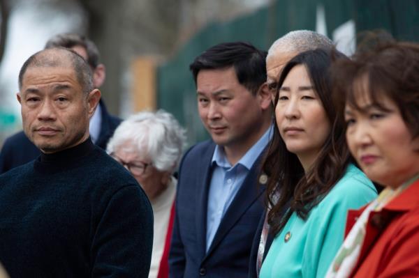 NYS Senator John Liu (thinning hair) , Assembly Member Ron Kim (blue suit) and other politicians held a press event in front of Dr. Young Seh Bae's (orange overcoat) now renovated house at 45-43 Francis Lewis Boulevard in Flushing, NY on April 10, 2024, to announce a bill better defining that squatters are intruders.