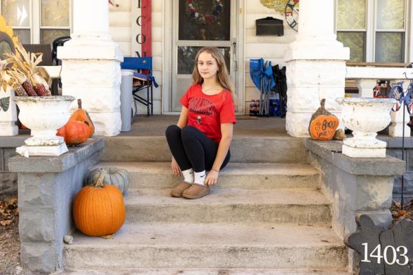 Cheyanne, 16, sits on her front steps of her home in Logansport.