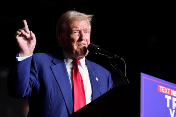 Former President Do<em></em>nald Trump speaking into a microphone during a campaign event at the World Market Center in Las Vegas, 2024