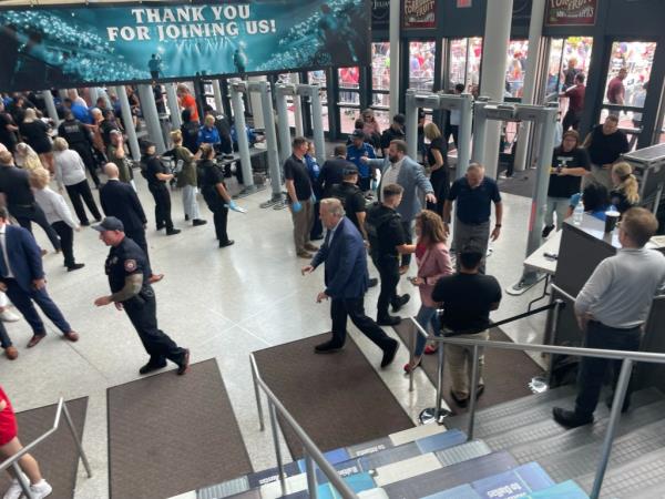 Security guards checking attendees at the entrance to the rally.