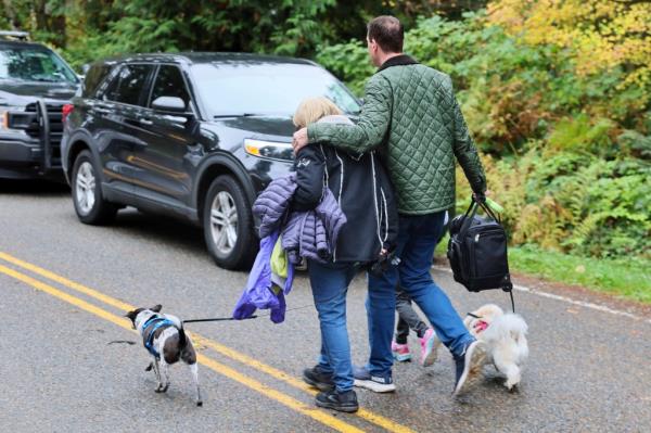 Neighbors walking away from the scene of a fatal shooting in Fall City, Washington, observed on the morning of October 21, 2024.