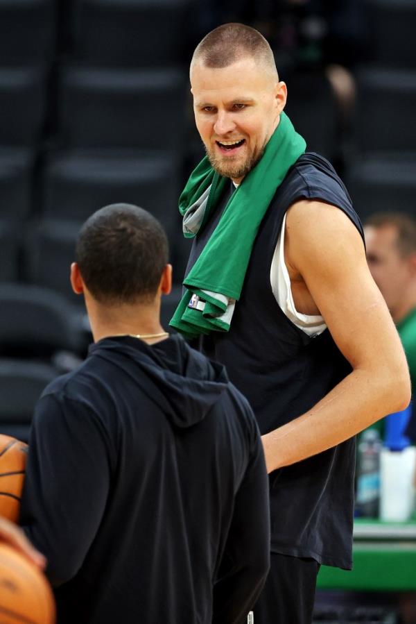 Kristaps Porzingis talks with Celtics coach Joe Mazzulla during a practice ahead of the NBA Finals.