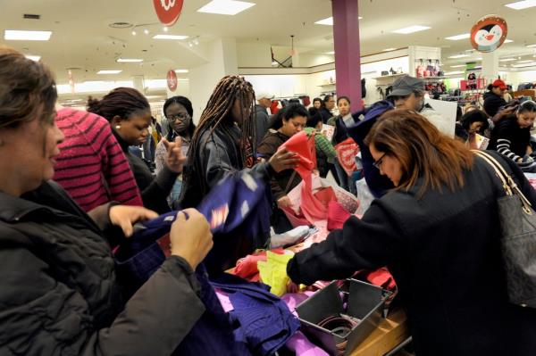 Shoppers rifle through piles of women's clothing in a JC Penney store on Black Friday.