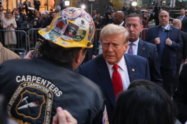 Do<em></em>nald Trump speaks with co<em></em>nstruction workers at the co<em></em>nstruction site of the new JPMorgan Chase headquarters in midtown Manhattan, Thursday, April 25, 2024, in New York.