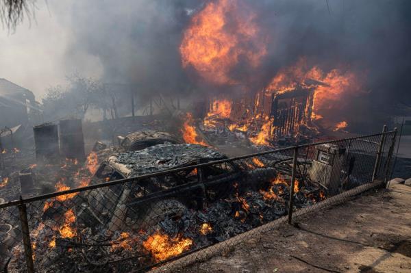 A house and vehicle being burned by the Mountain Fire. 