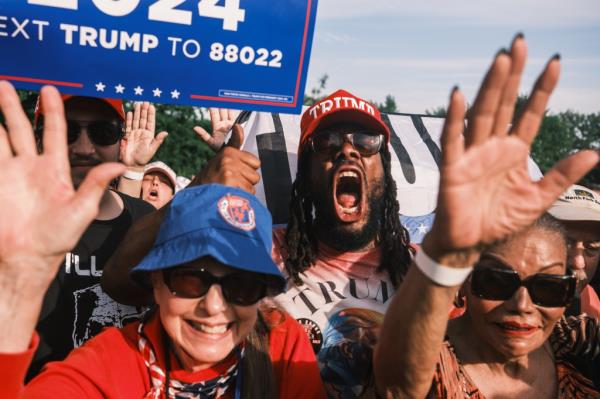 People attending a campaign rally for former US president Do<em></em>nald Trump in Cortona Park, Bronx, New York, holding signs; Christine Wenzel spotted among the crowd.