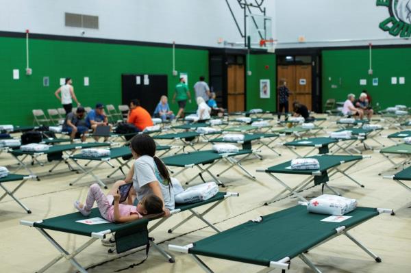 People arriving at an emergency shelter at at Eastern New Mexico University-Roswell.