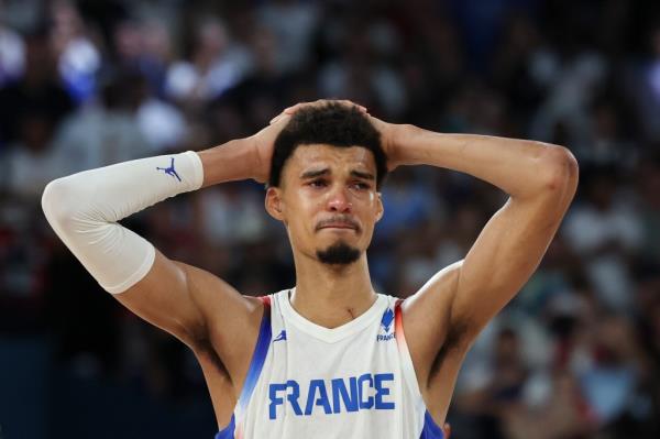 Victor Wembanyama fights back tears after France's loss in the gold medal game.