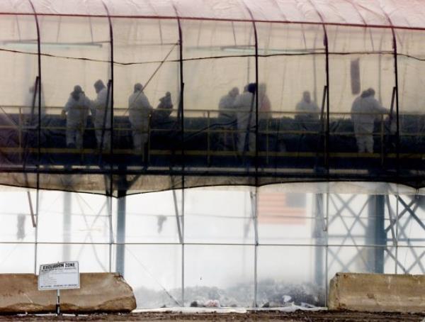 NEW YORK, UNITED STATES: Workers sift through debris from the World Trade Center at Fresh Kills Landfill 14 January, 2002. Workers search for perso<em></em>nal property and remains of those who perished in the collapse. Crews at ground zero have removed 951,272 tons of debris and steel as of 03 January, according to city officials. That is roughly three fourths of the 1.2 million tons that covered the area at the outset, according to estimates by the Federal Emergency Management Agency. AFP PHOTO/Don EMMERT (Photo credit should read DON EMMERT/AFP via Getty Images)