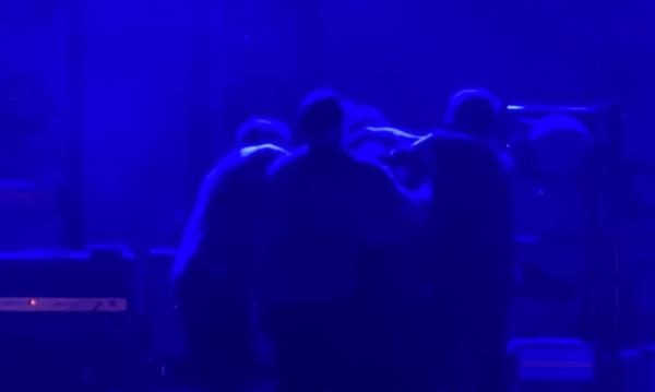 The lights lowered on stage, but several punches were thrown as the hot-headed singer was escorted away from the crowd's view.