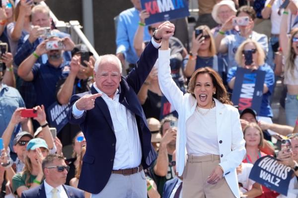 Walz raising Harris' arm in the air at the Eau Claire rally.