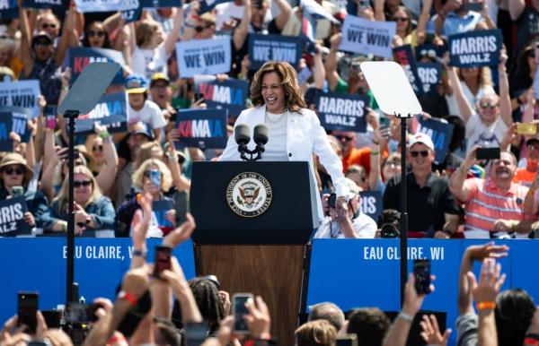 Vice President Kamala Harris speaking at a campaign rally in Eau Claire, Wisconsin, with Tim Walz in the crowd, August 7, 2024