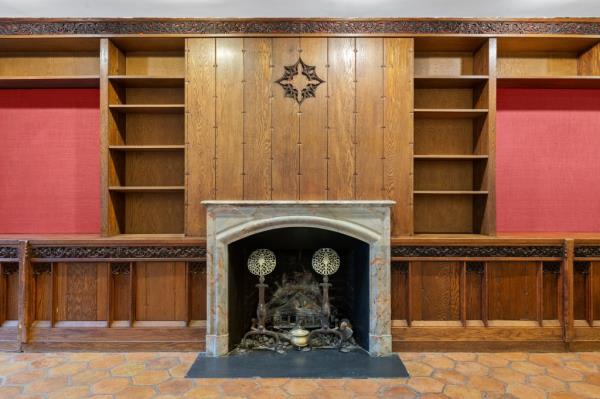 The historic brownstone was built in 1872 and still has original details like this mantel. 