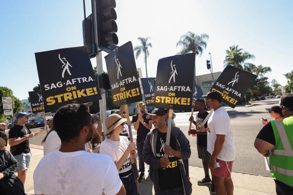 SAG-AFTRA members walk the picket line during their o<em></em>ngoing strike, in Los Angeles