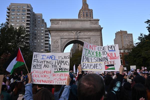 Protestors hold signs in Washington Square Park. 